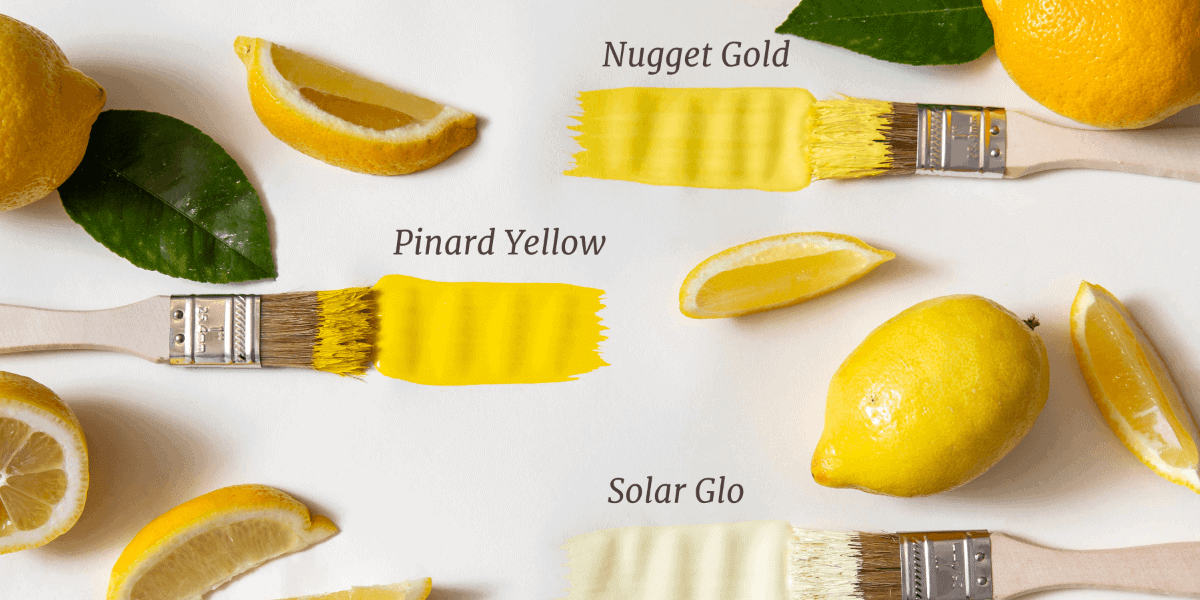 A yellow paint brush with lemons and leaves on a white background.