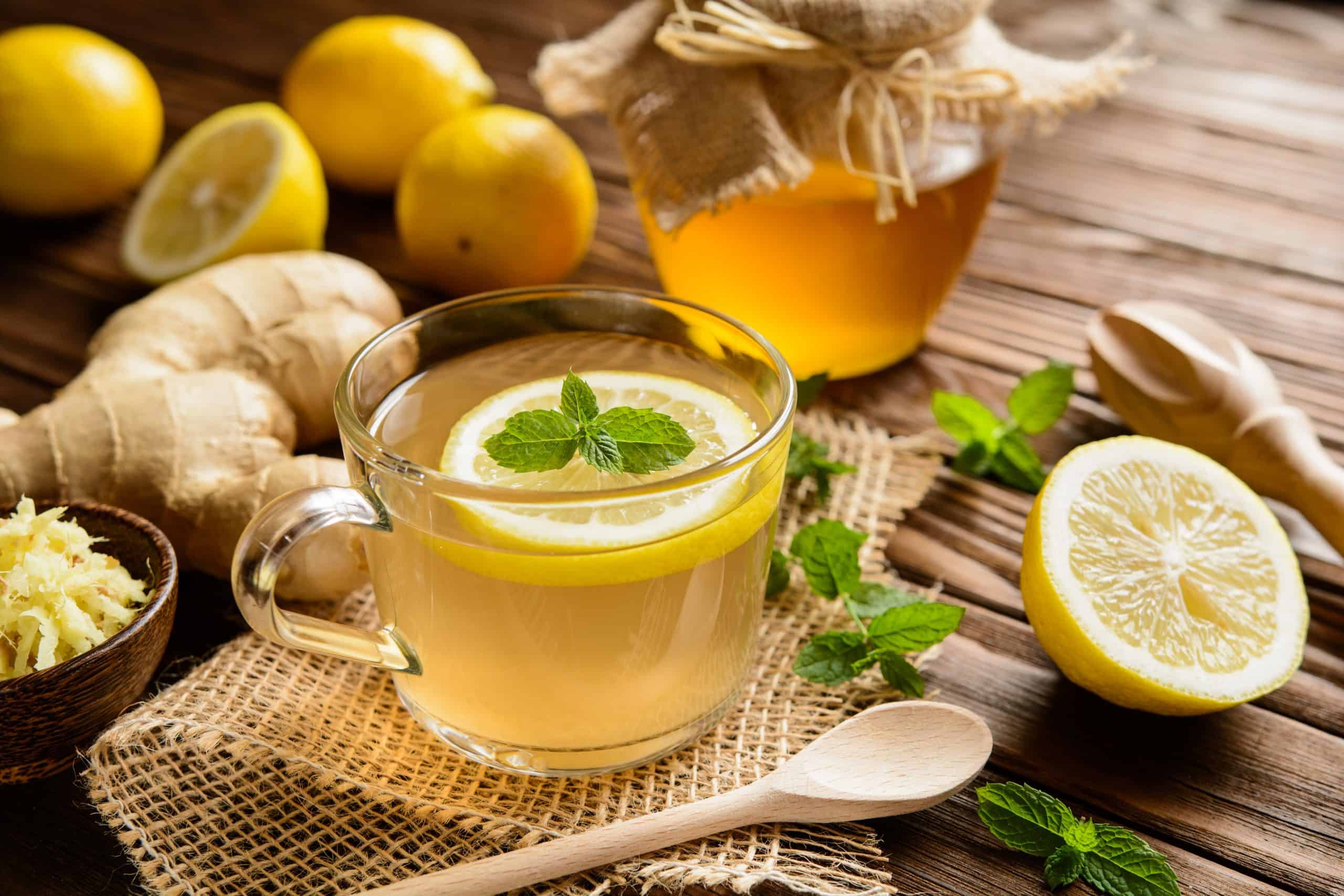 Cup of tea with lemon slice and mint garnish. 