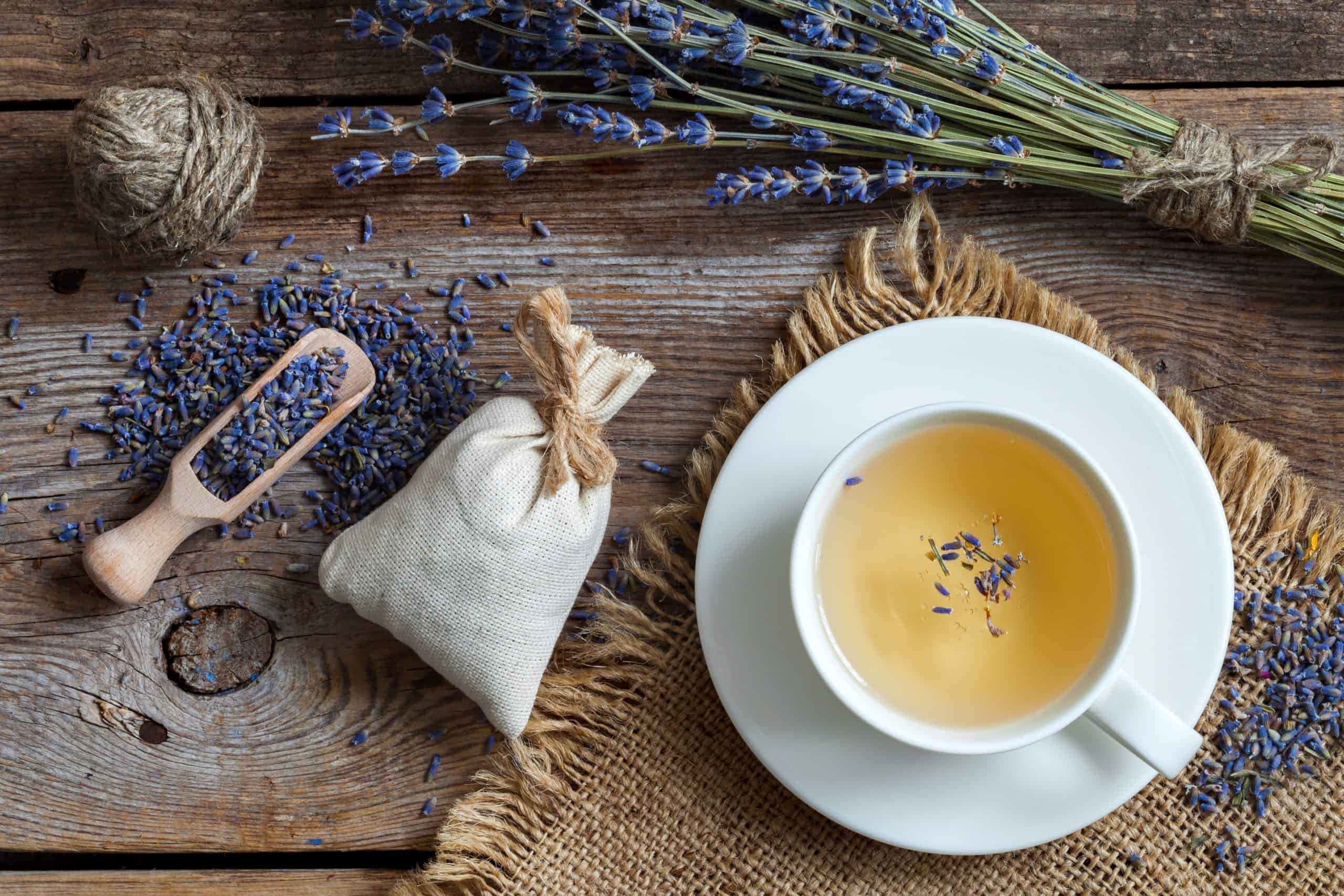 Top view. Bunch of lavender flowers, sachets filled with dried lavender and healthy tea. 