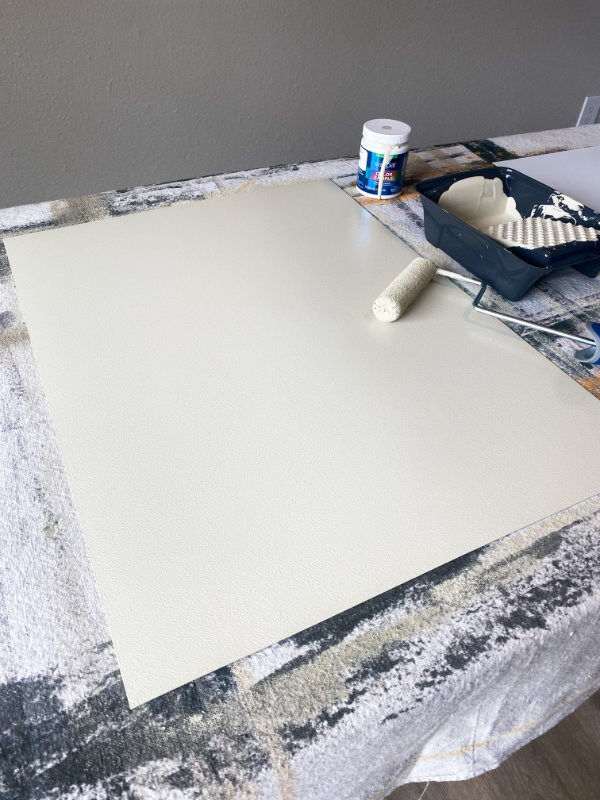 Painted board with a paint roller sitting on top