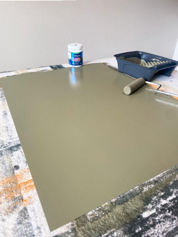 Painted board with a paint roller sitting on top