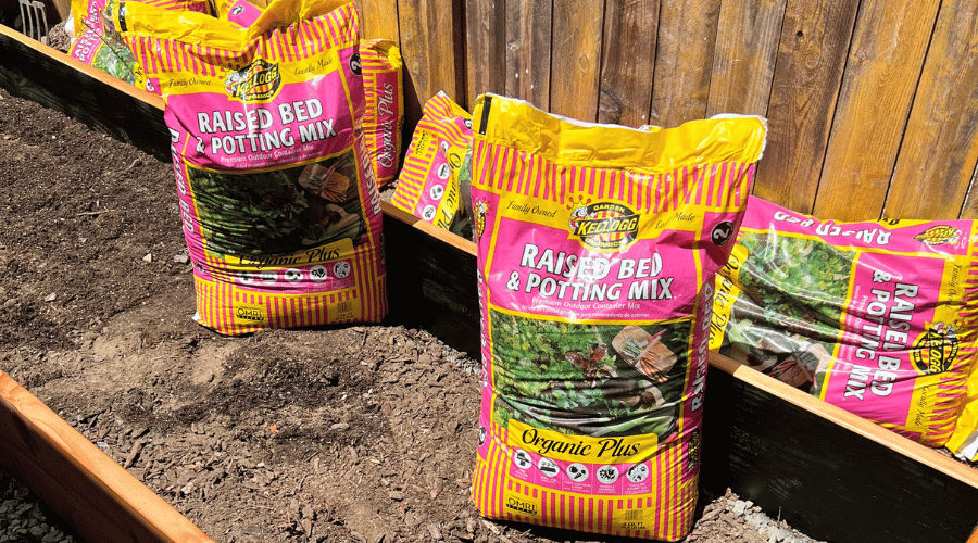 Raised garden bed with bags of potting mix