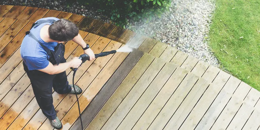 Man power spraying a deck