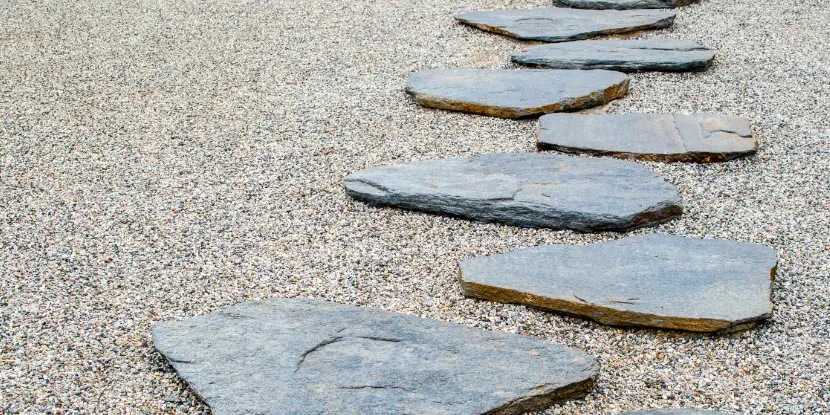 A flagstone path surrounded by gravel