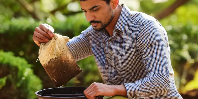 A gardener prepares a batch of compost tea