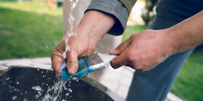 Man cleaning a paint brush