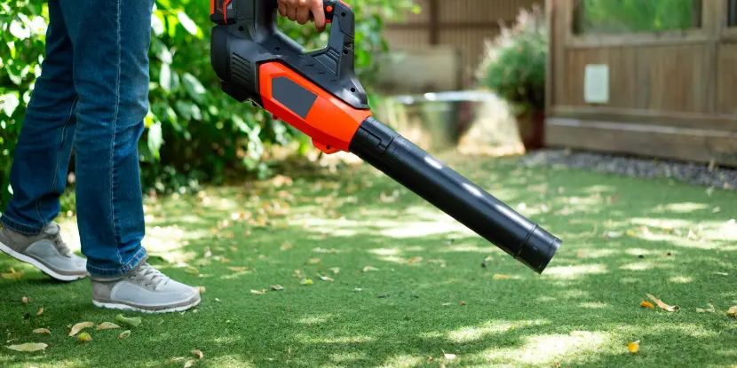 A man operates a leaf blower