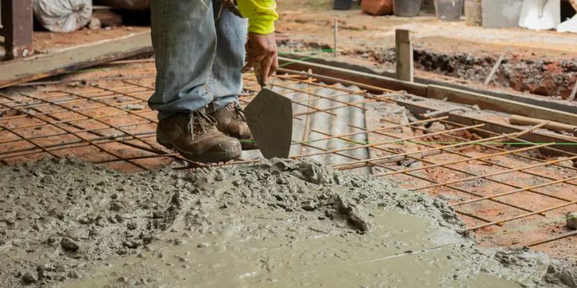 Pouring concrete in a mold reinforced with rebar