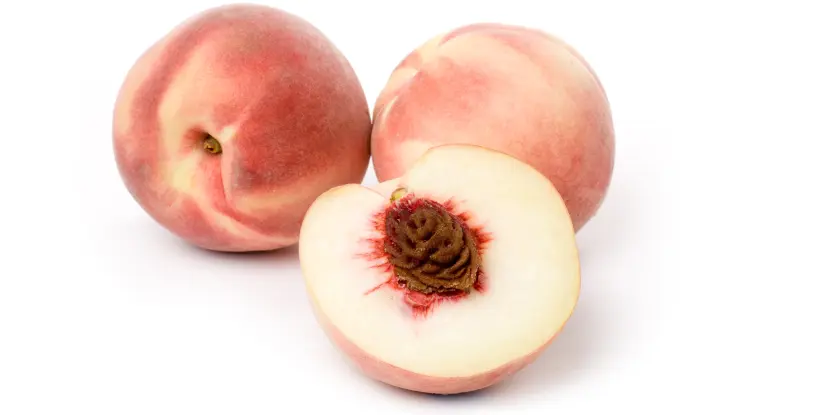 A sliced peach with white flesh