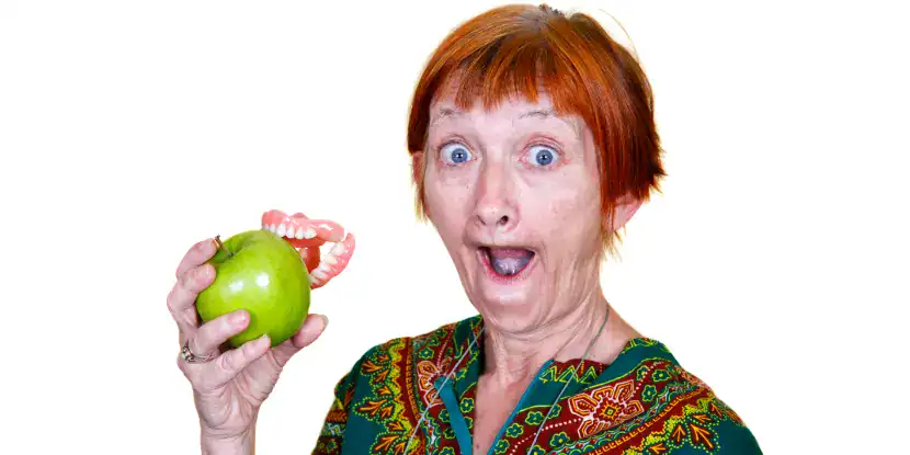 A grandma with missing teeth and a Granny Smith apple