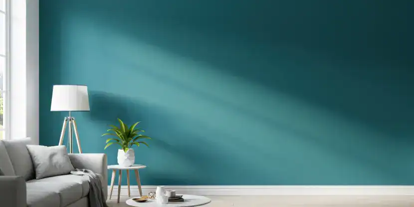 A room with teal walls and contrasting white trim
