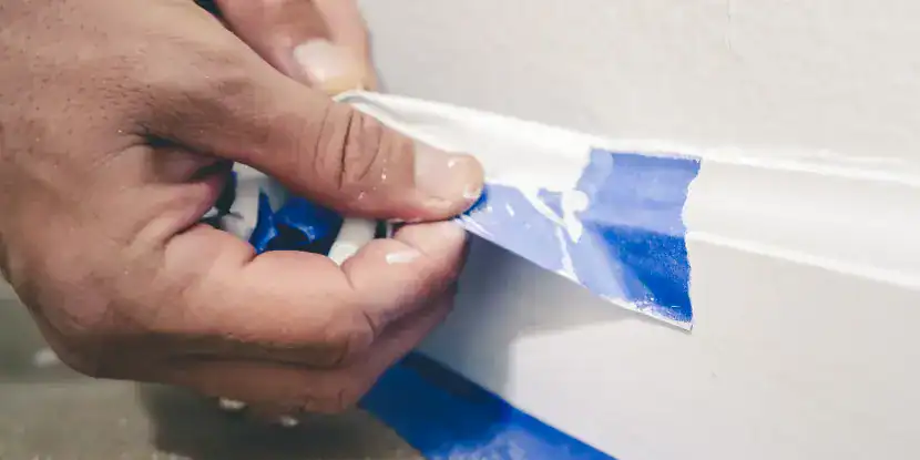 A man removing painter’s tape