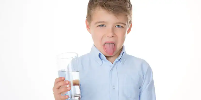 A boy tastes bad water