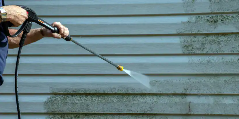 Power washing a house exterior