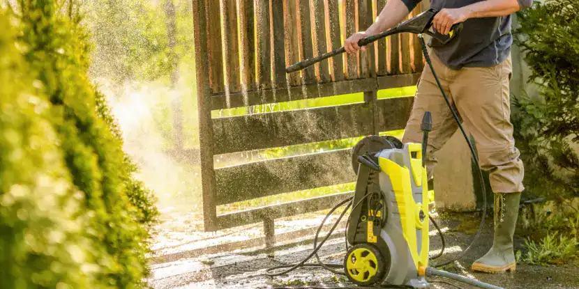 A power wash refreshes a wood fence