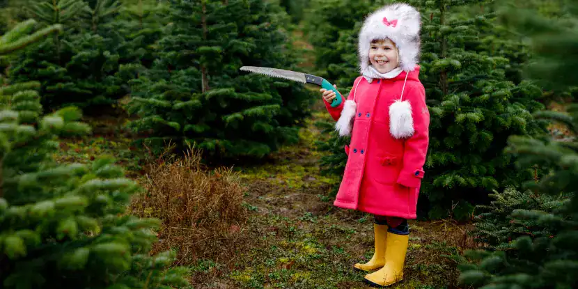 A little girl wields a tree saw