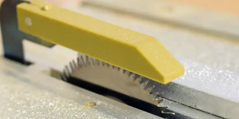 A plastic blade guard shields a saw blade
