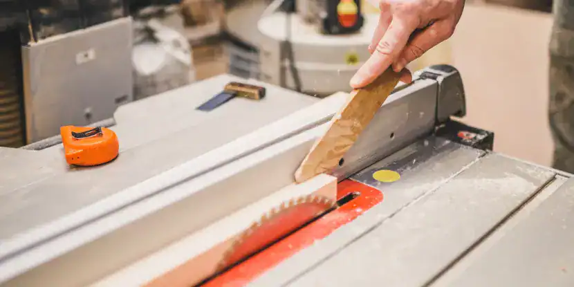 A woodworker uses a push block