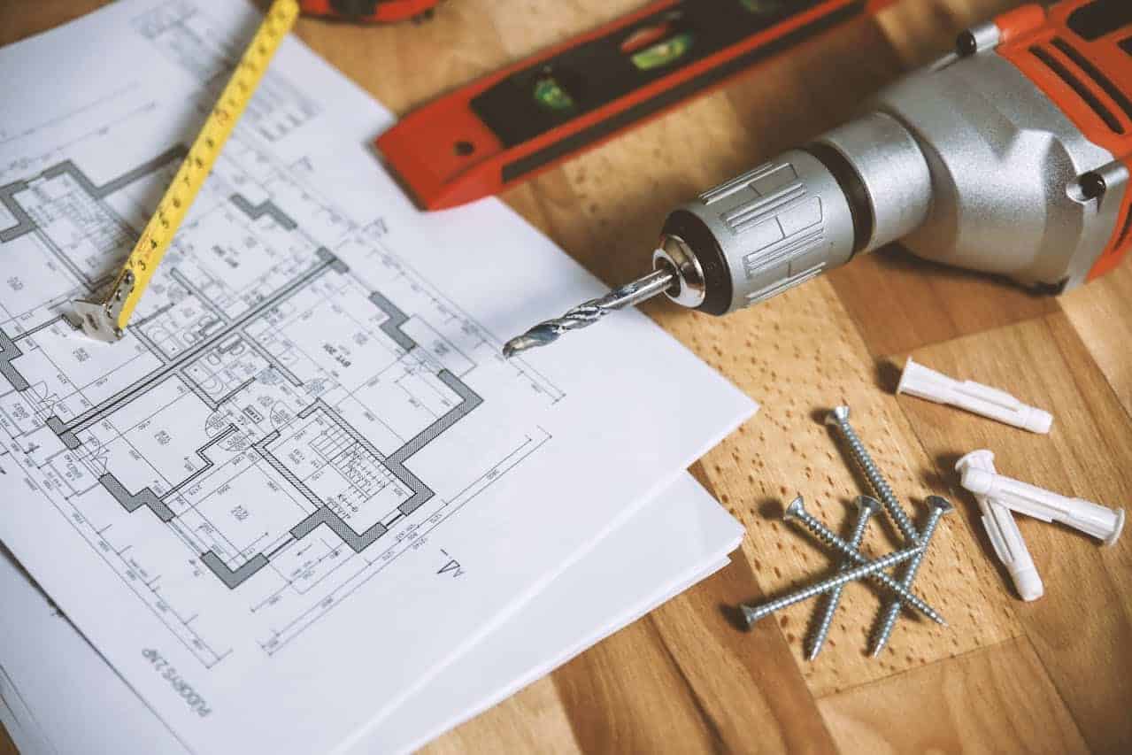 types-of-concrete-anchors-1 Cordless drill, blueprints and wall anchors on a table, showing tools used to install types of concrete anchors