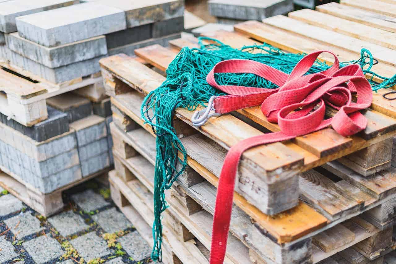 Stacked concrete pavers and wooden pallets, a reminder to match types of concrete anchors to the base material